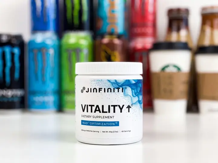 Jinfiniti Vitality+ NAD+ supplement jar in front of blurred energy drink cans and bottled coffees