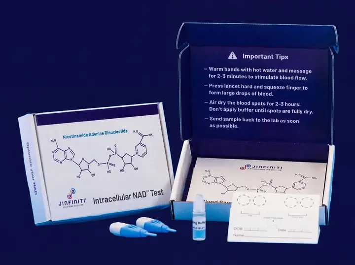 Jinfiniti Intracellular NAD Test kit opened, showing the box, blood collection card, lancets, and instructions